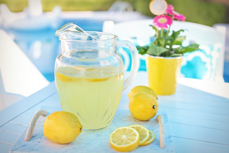 lemonade in a pitcher by a pool